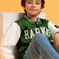 Junior boy sitting casually in a green varsity jacket and jeans
