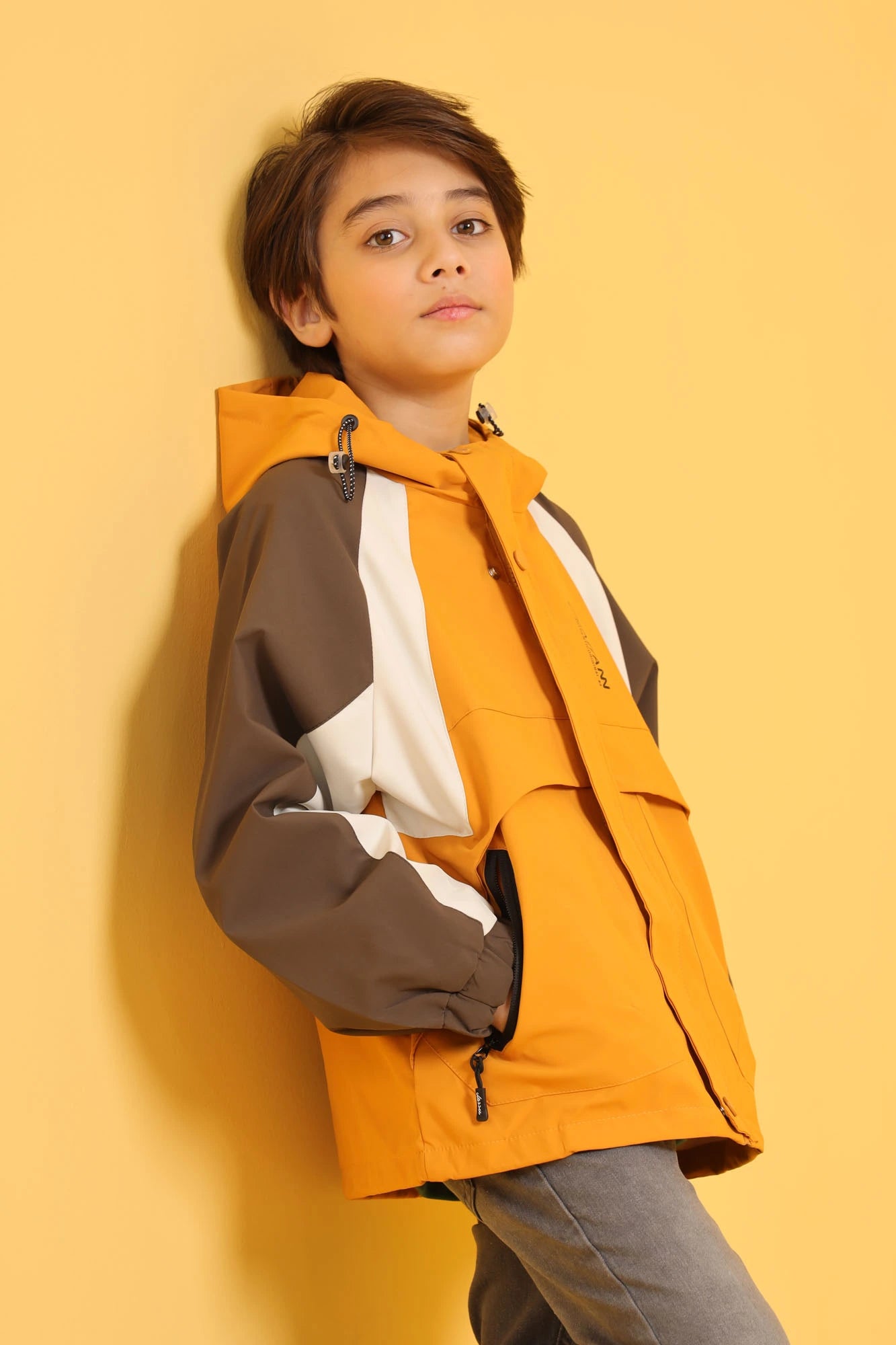 Side profile of junior boy wearing Breaker Jacket in Harvest Gold