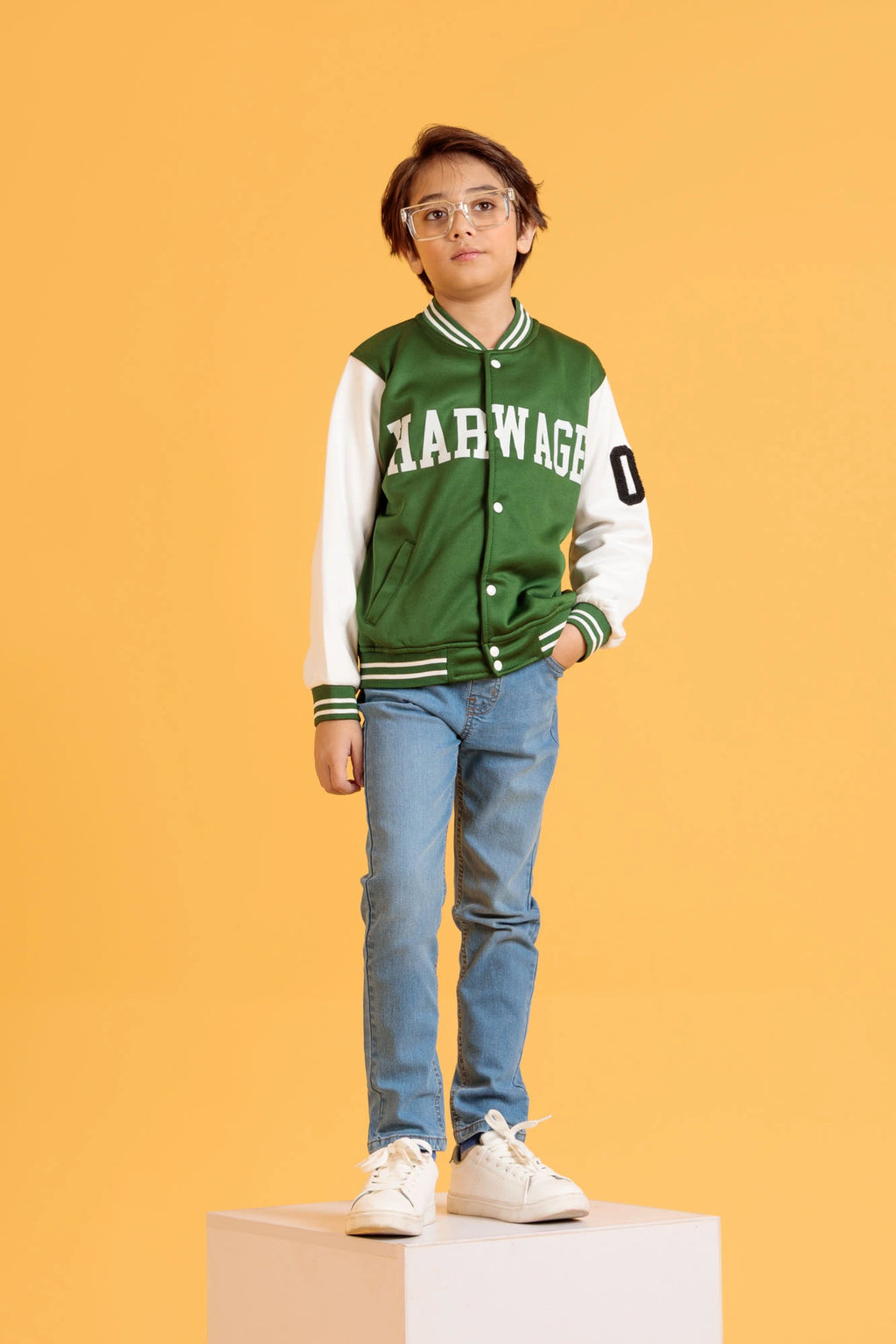 Junior boy wearing a Jacket in Bronze Green with white sleeves