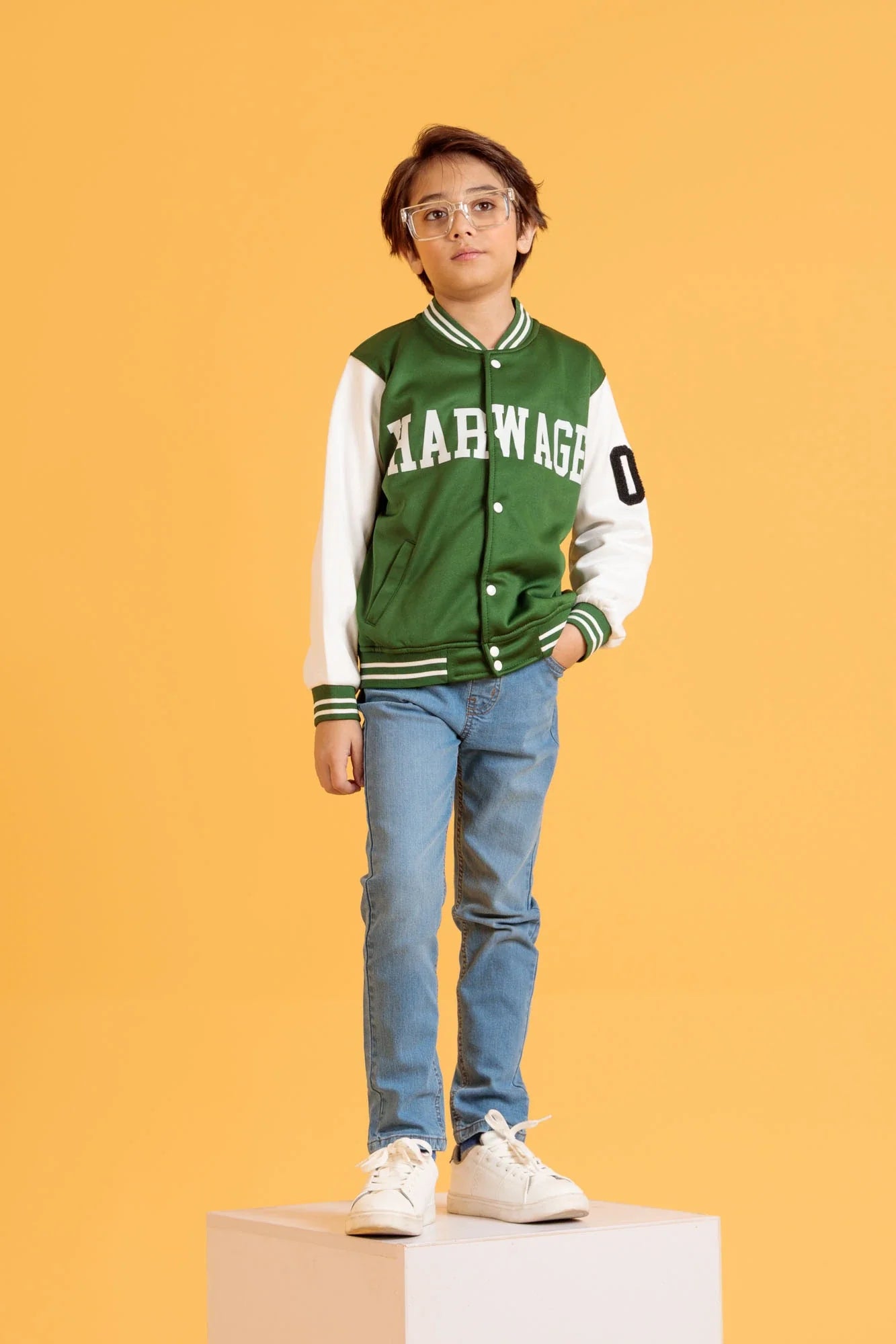 Junior boy wearing a Jacket in Bronze Green with white sleeves