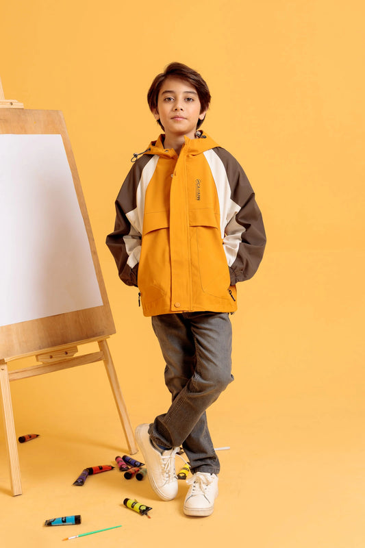 Front view of junior boy modeling Breaker Jacket in Harvest Gold