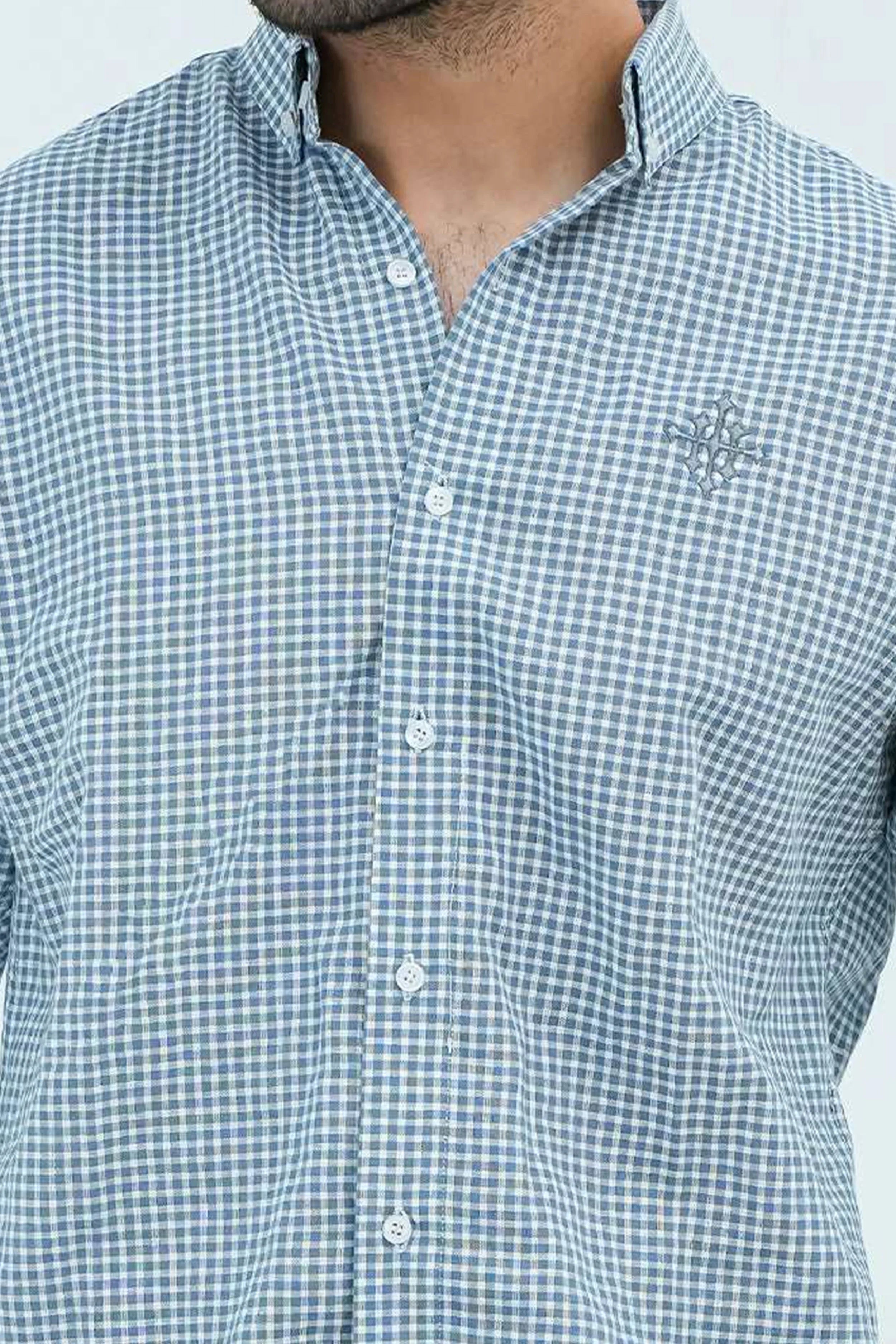 Close-up of checkered blue casual shirt fabric and buttons