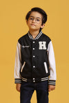 Child model posing in a Baseball Jacket in Black with white sleeves