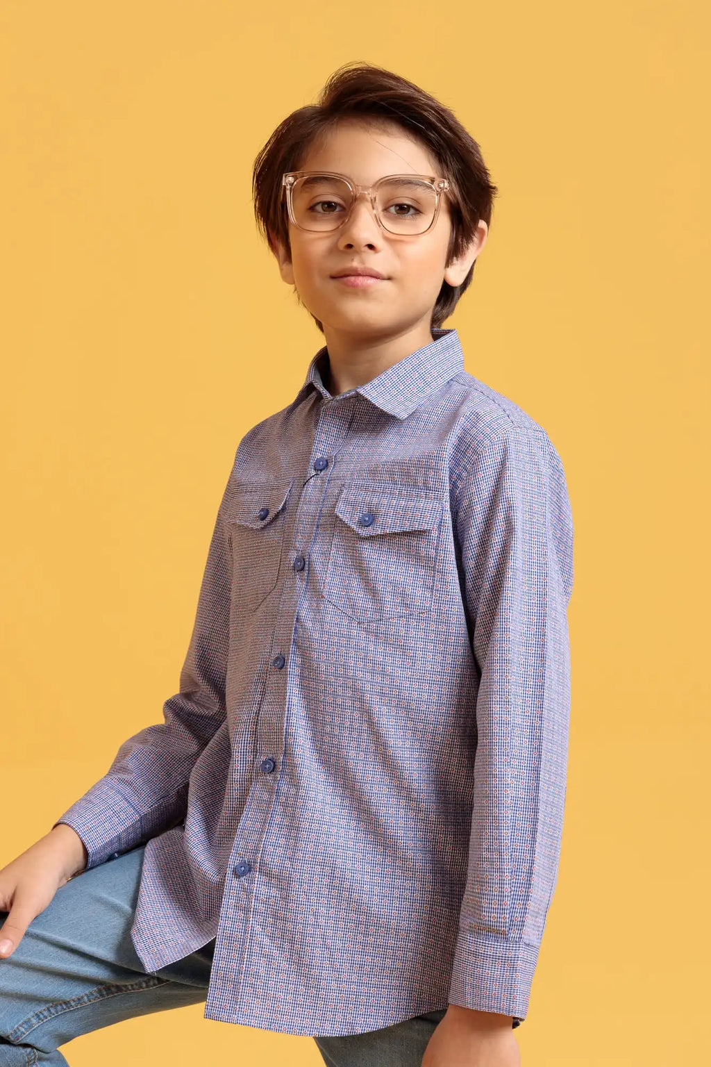 Child wearing a checkered shirt and glasses