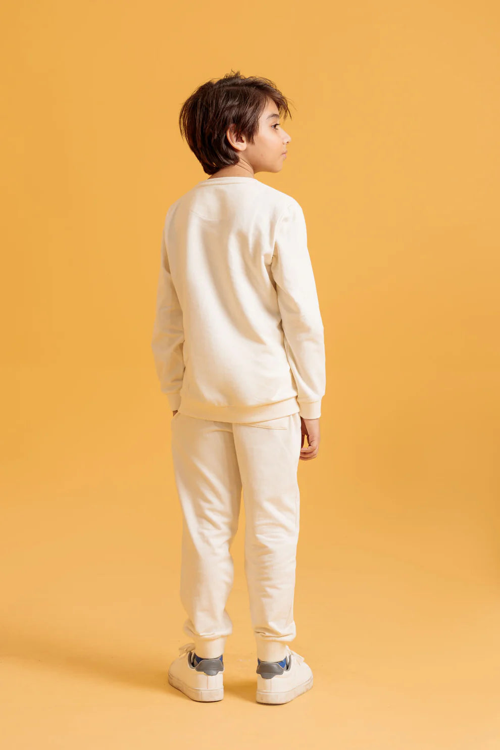 A child wearing a white outfit 