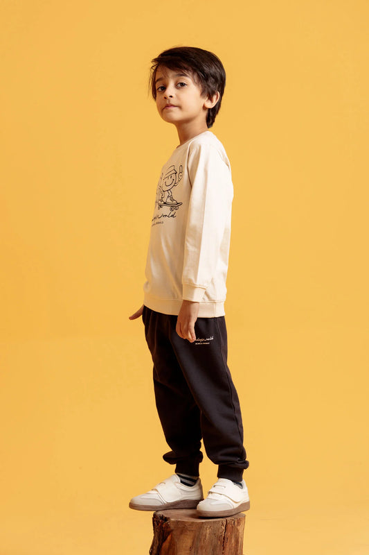 Child wearing a white sweatshirt with a graphic design on a yellow background

