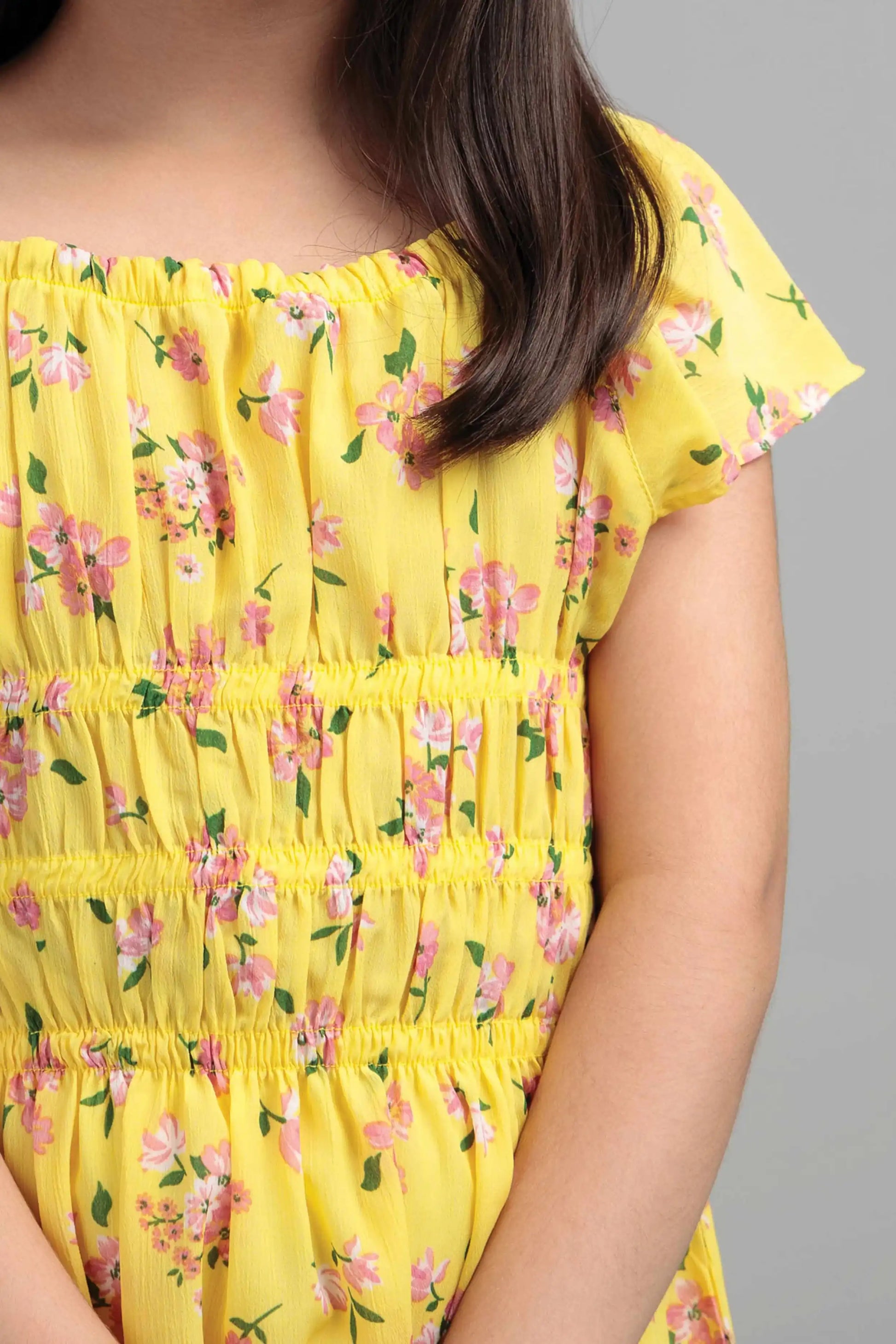 Child wearing a yellow dress