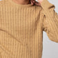 Man wearing beige crew neck cable knit sweater front view