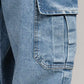 Close-up of a blue denim pocket on a gray background