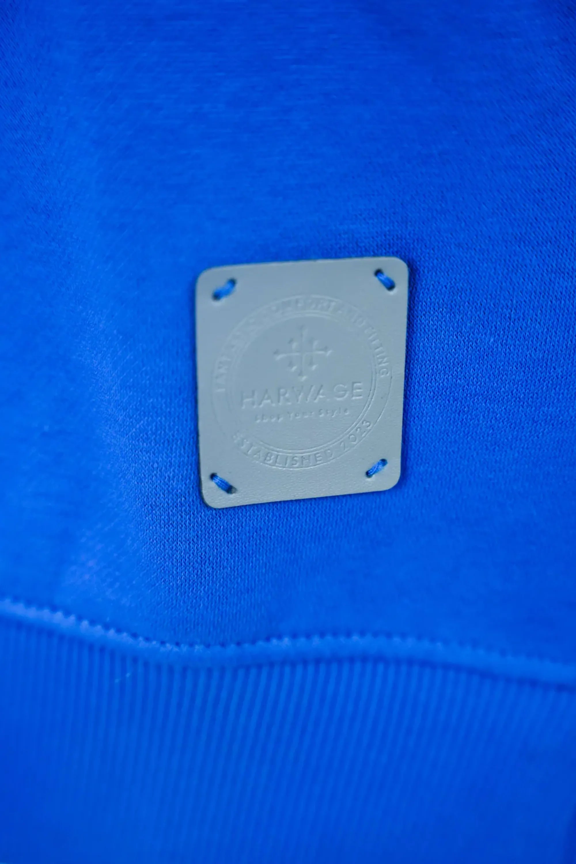 Close-up of a blue fabric with a brand label on it