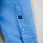 Close-up of a blue shirt sleeve with a brand logo