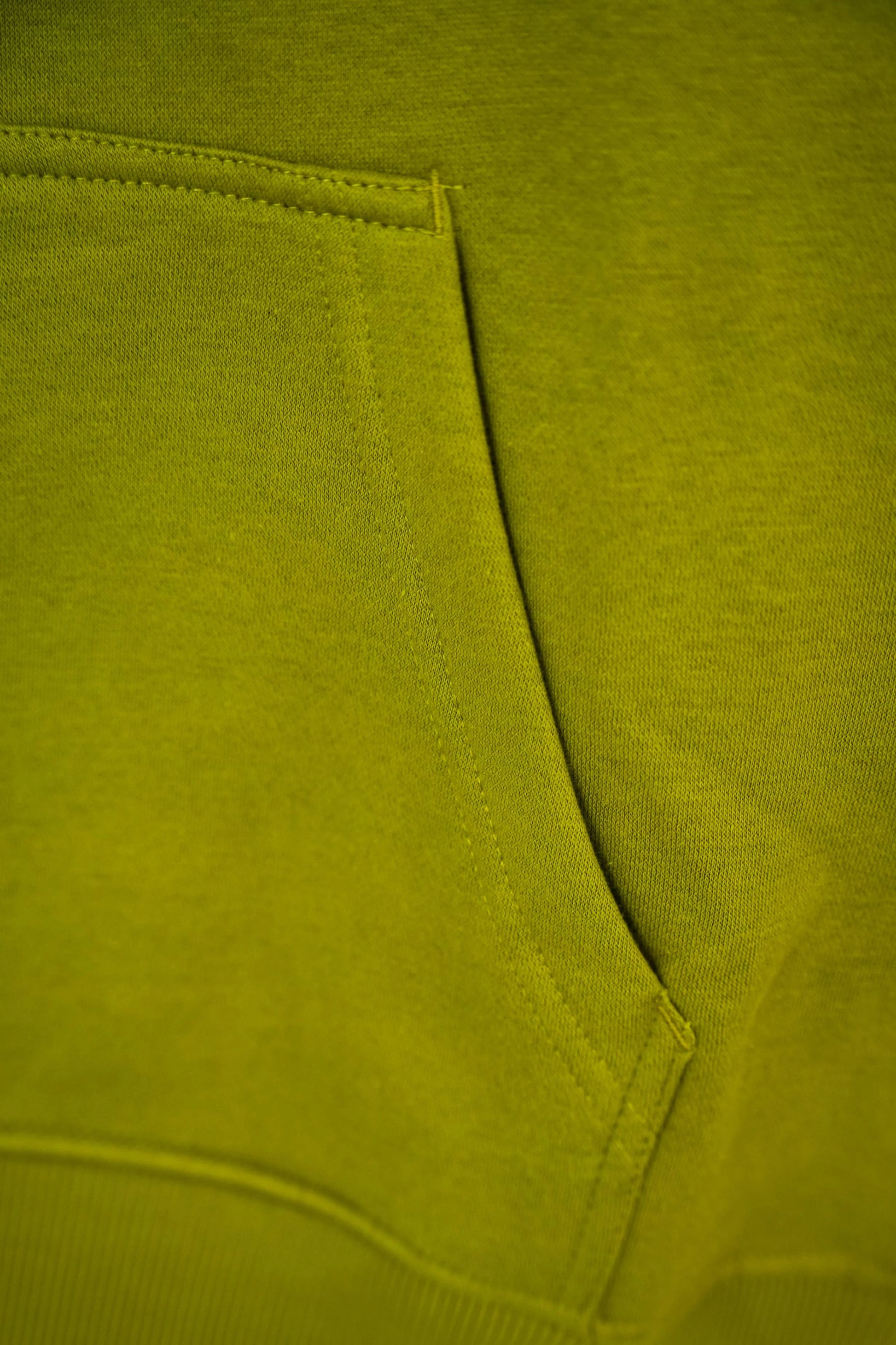Close-up of a green fabric with a pocket