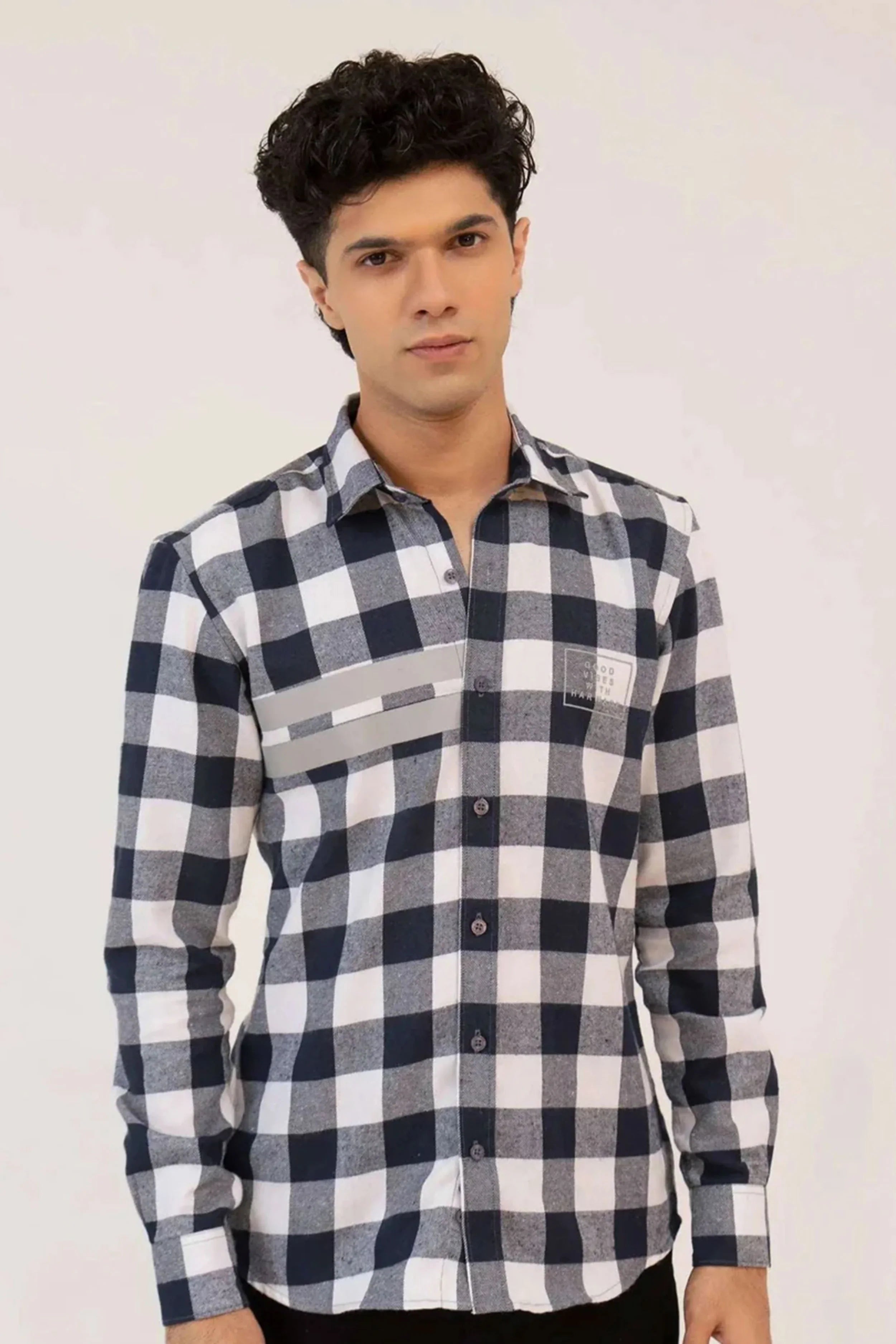 Close-up of a man’s black and white checkered shirt