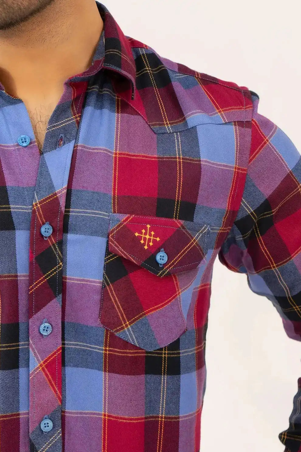 Close-up of a plaid shirt with a visible brand logo
