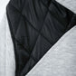 Close-up of a quilted jacket with black and gray fabric