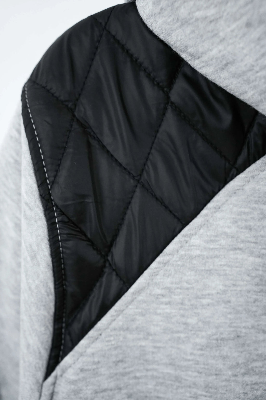 Close-up of a quilted jacket with black and gray fabric