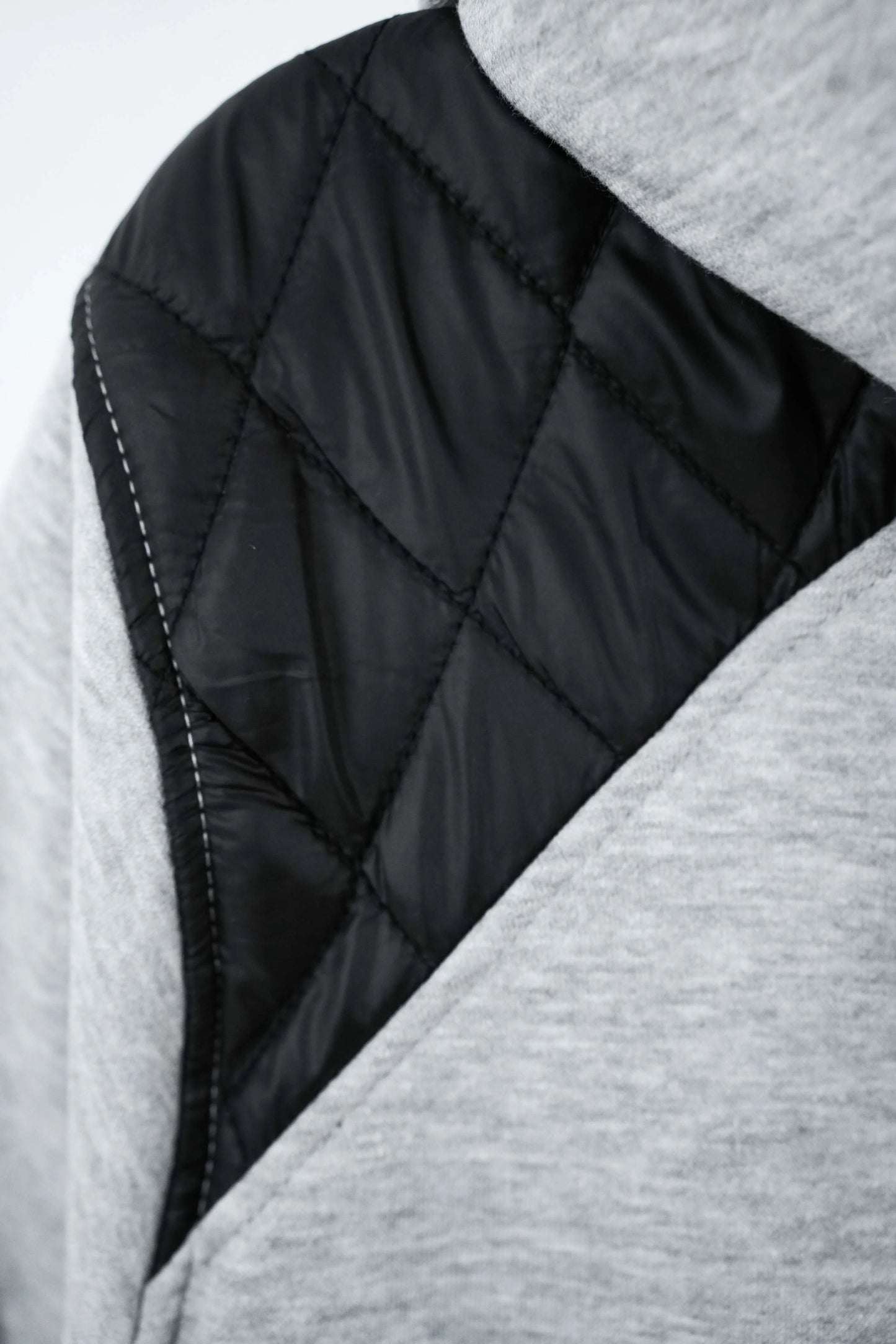 Close-up of a quilted jacket with black and gray fabric