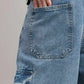 Close-up of blue jeans with a pocket, worn by a person