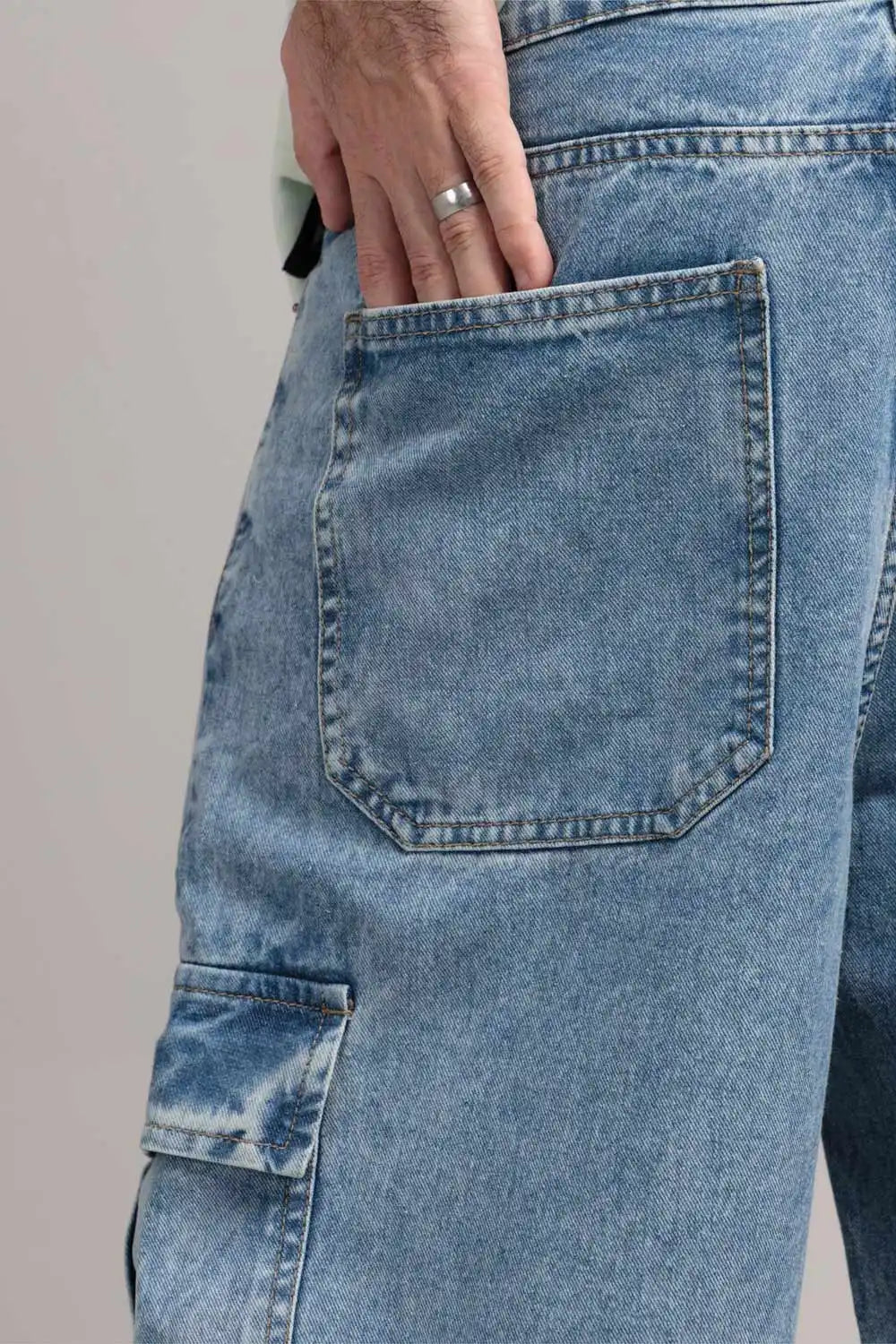 Close-up of blue jeans with a pocket, worn by a person