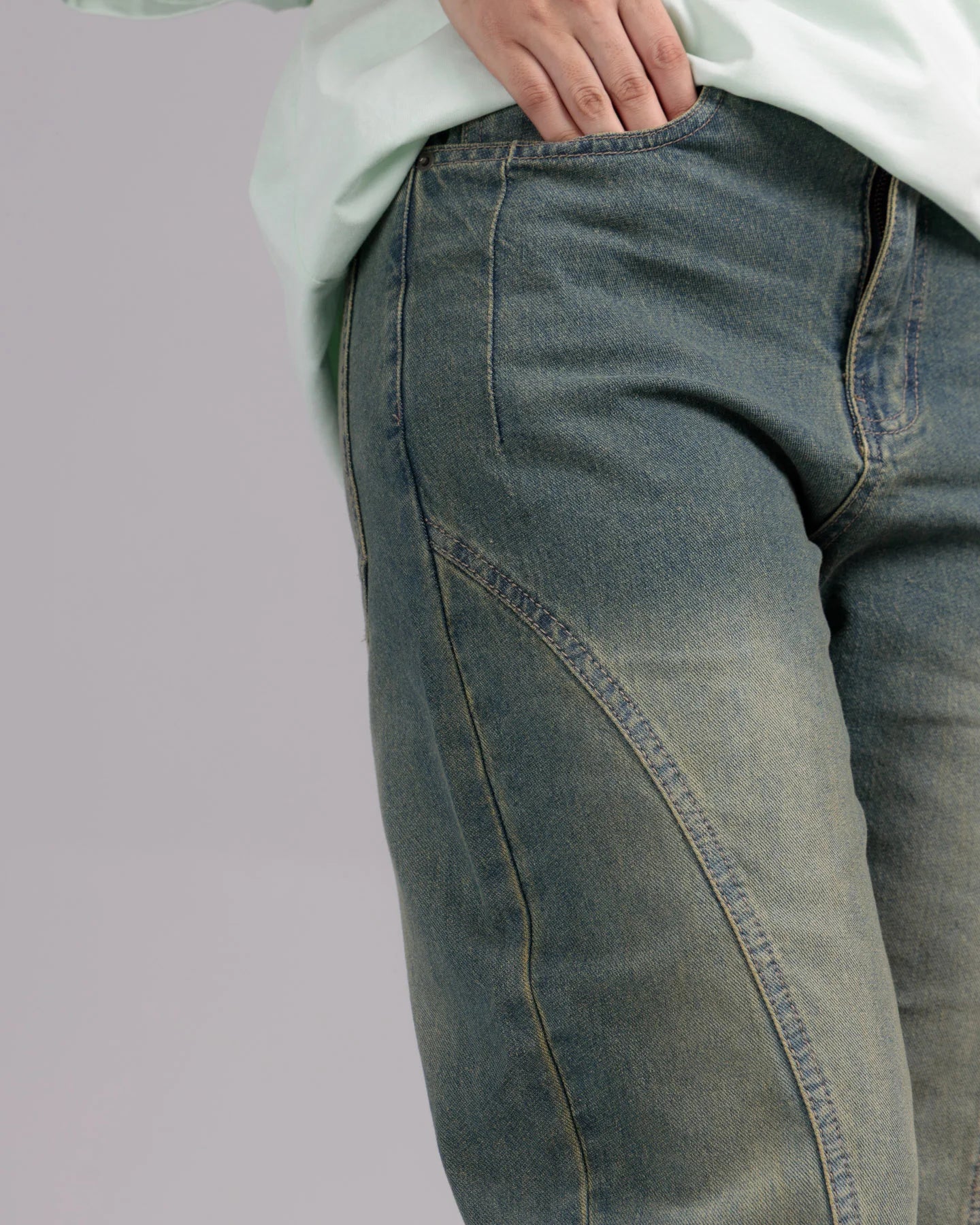 Close-up of blue jeans on a plain background