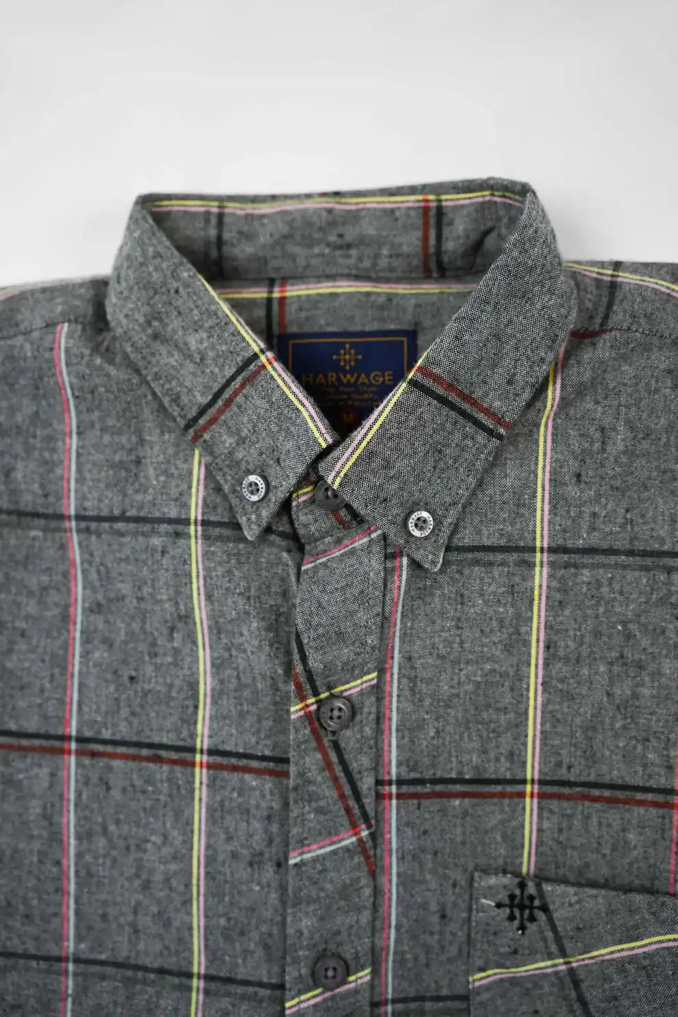 Close-up of gray plaid shirt collar and buttons
