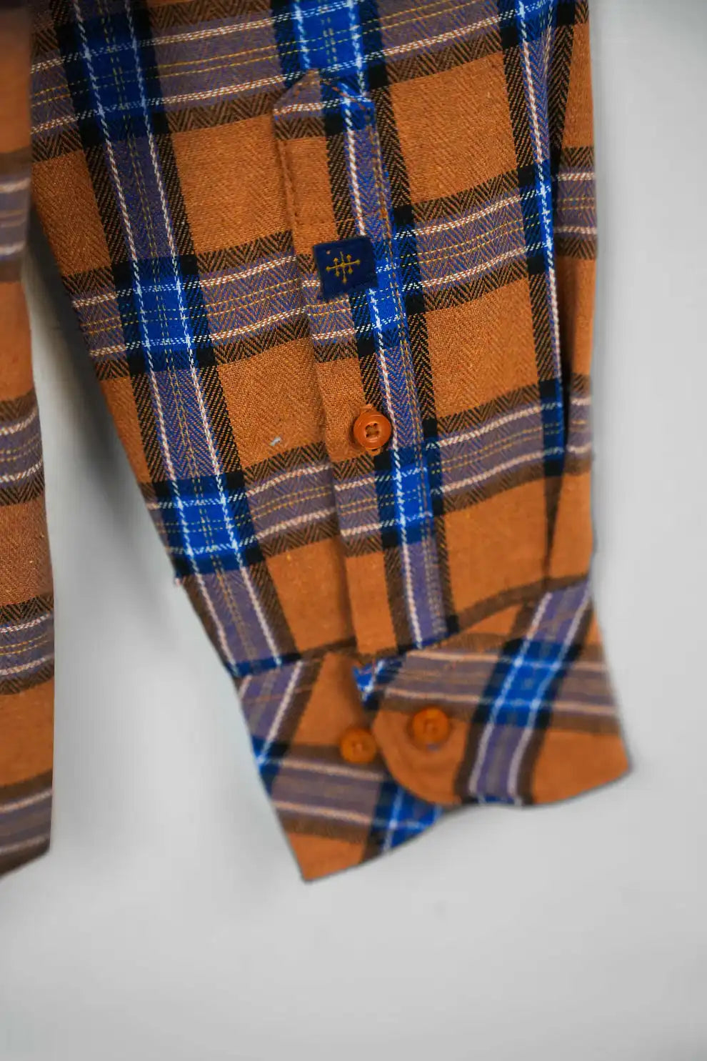 Close-up of orange and blue pattern shirt cuff