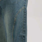 Close-up of blue jeans on a plain background