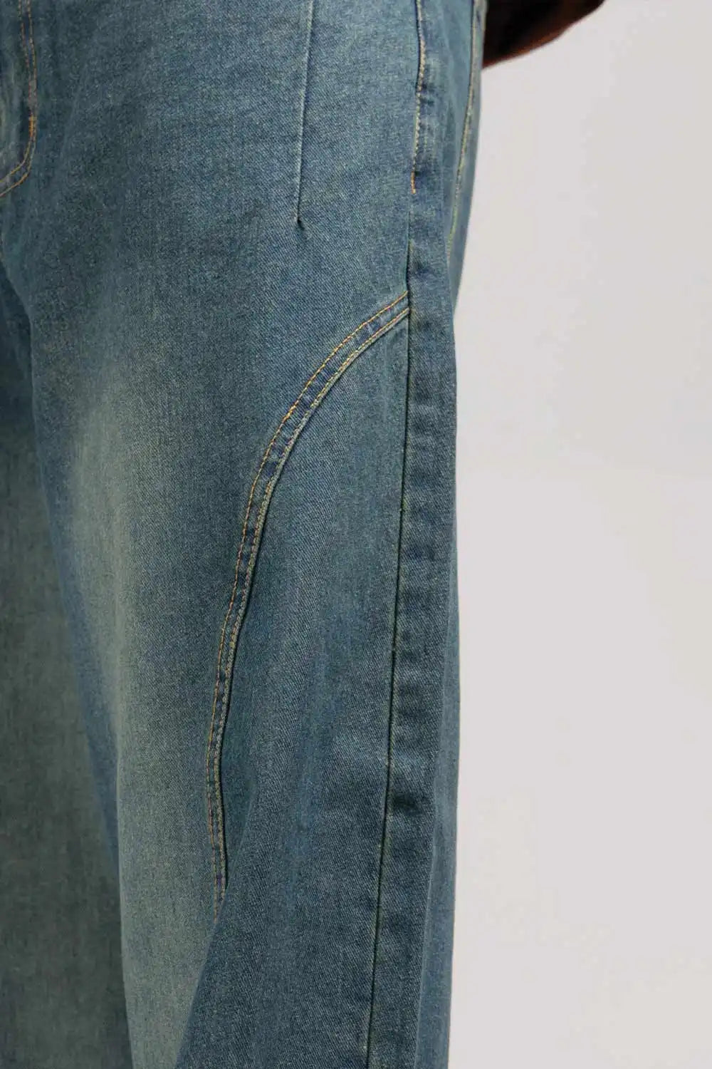 Close-up of blue jeans on a plain background