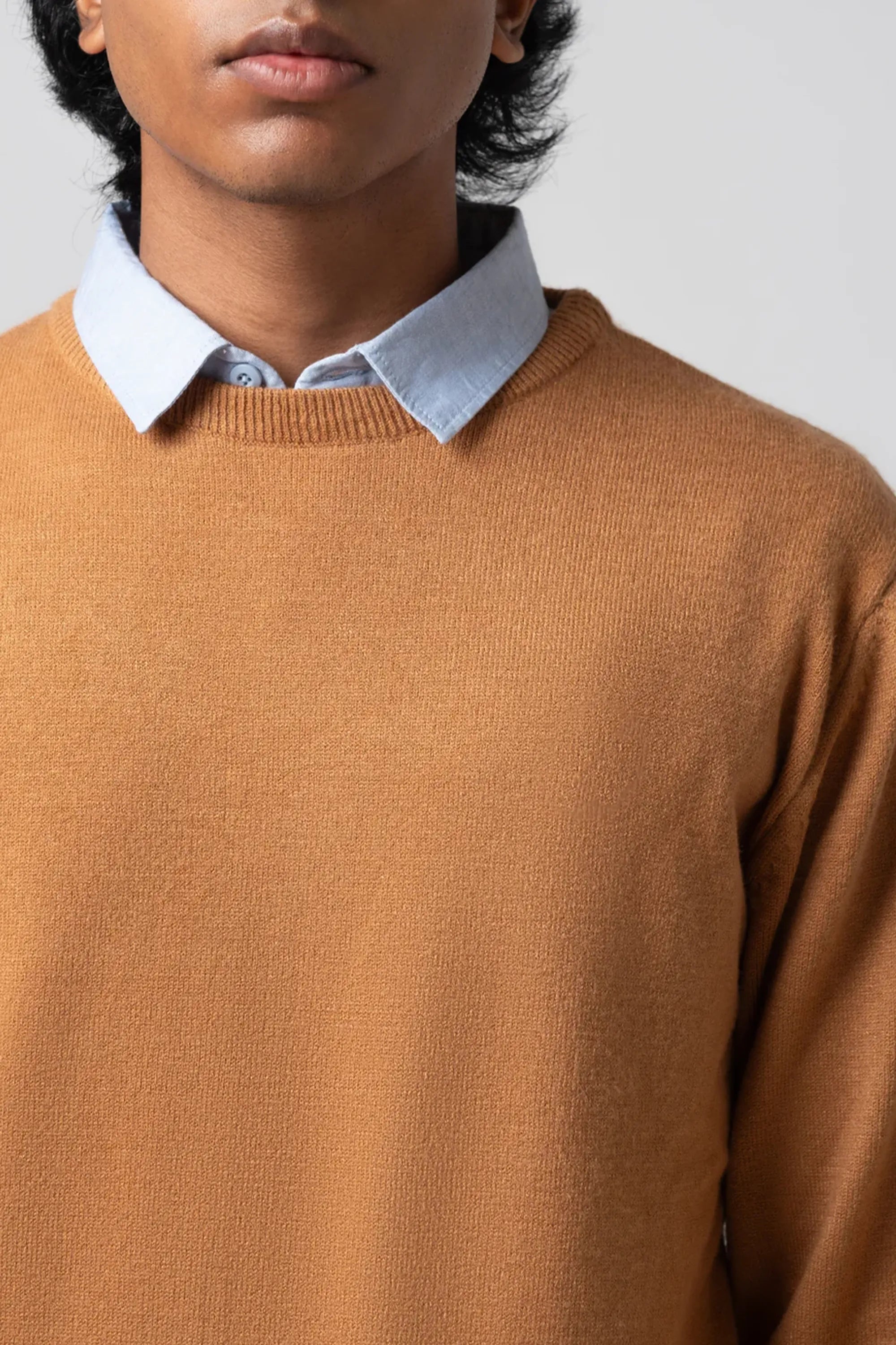 Upper body close up showing neckline and fabric of mustard sweater
