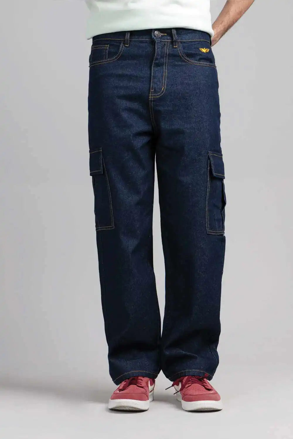 Person wearing dark blue cargo pants on a plain background
