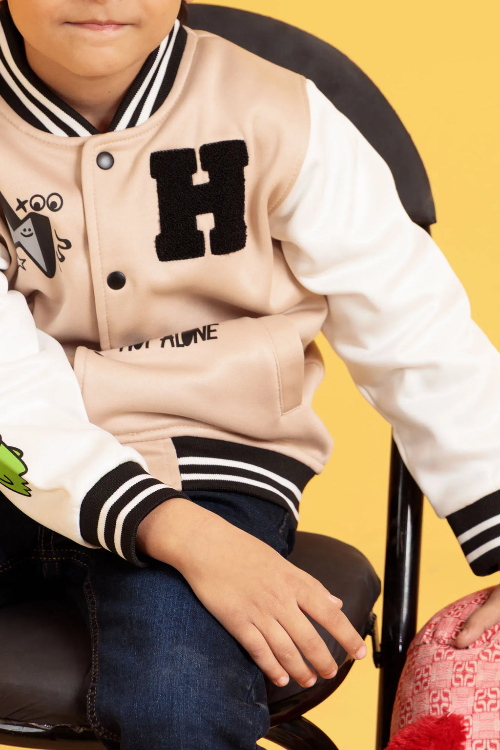 Detail view of boys' turtledove baseball jacket front design