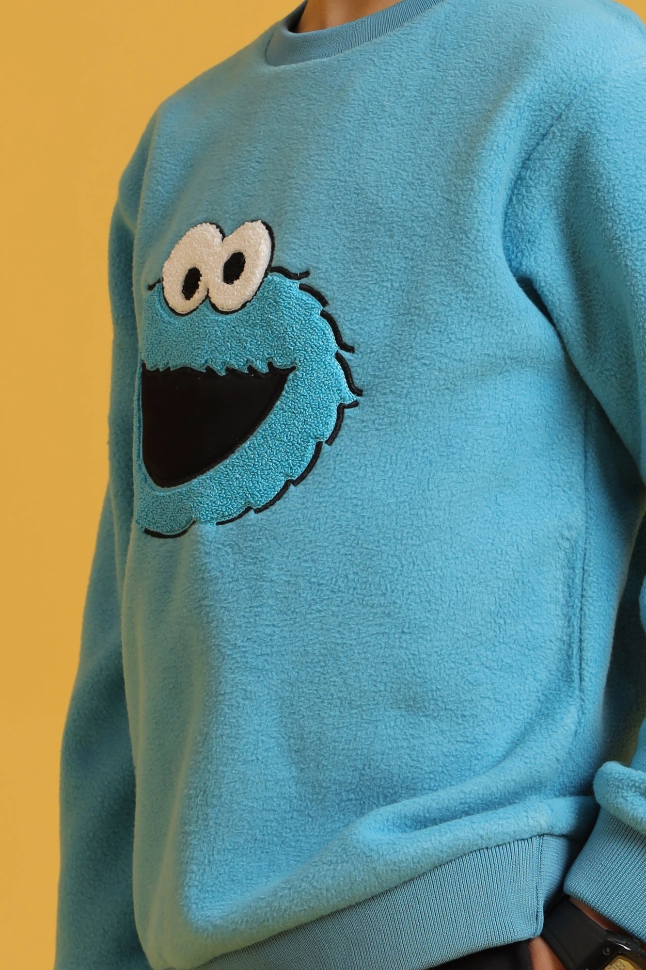 Embroidered character detail on boys' blue sweatshirt