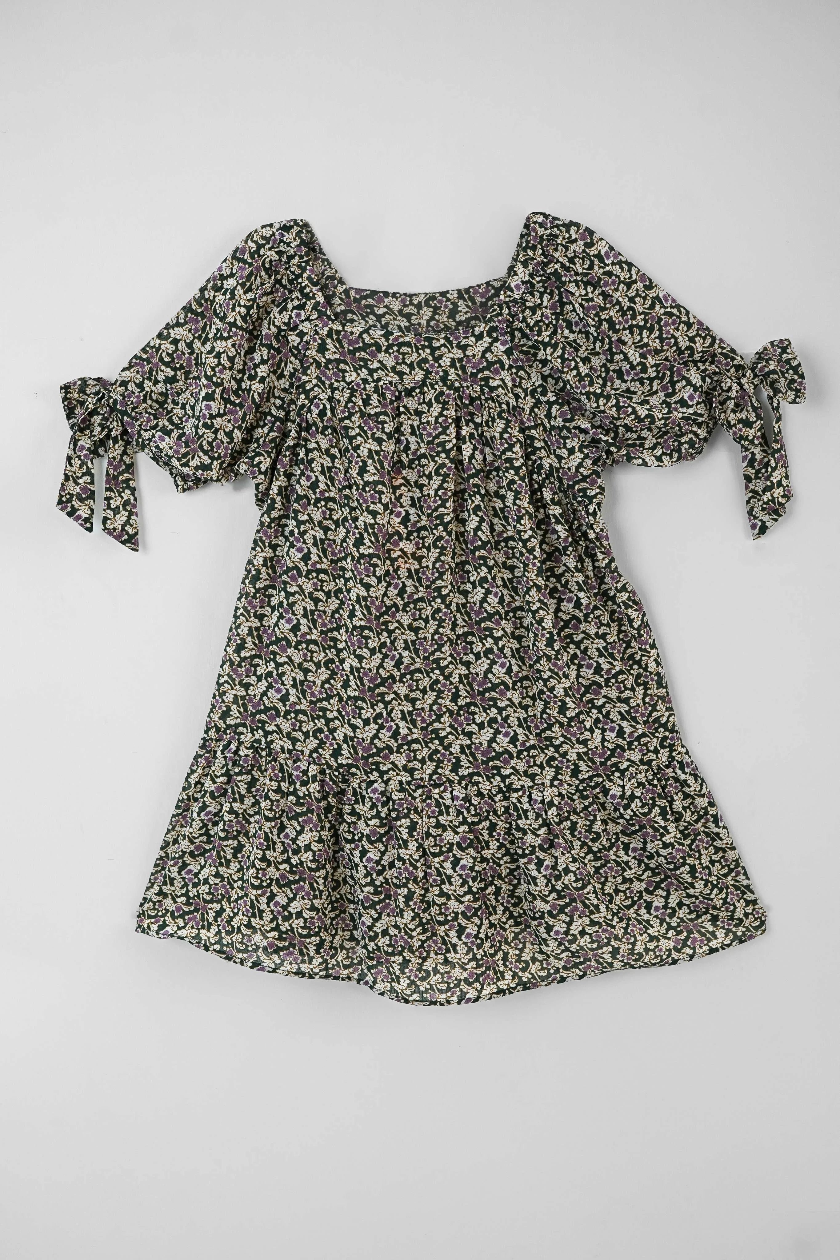 Floral top with bow detail on a white background