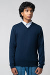 Front-facing pose wearing men's v neck cardigan navy with jeans
