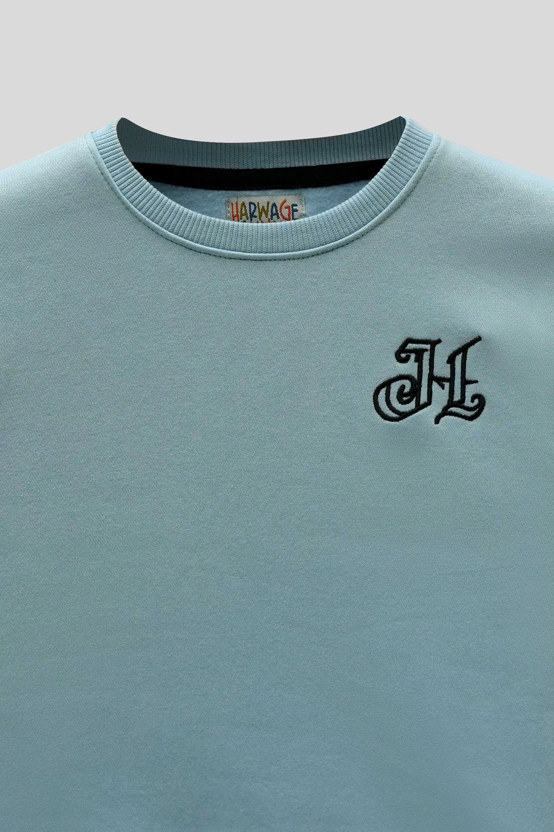 Front neckline and logo detail on boys aqua sweatshirt