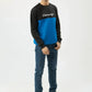 Relaxed front stance showcasing blue and black sweatshirt panels
