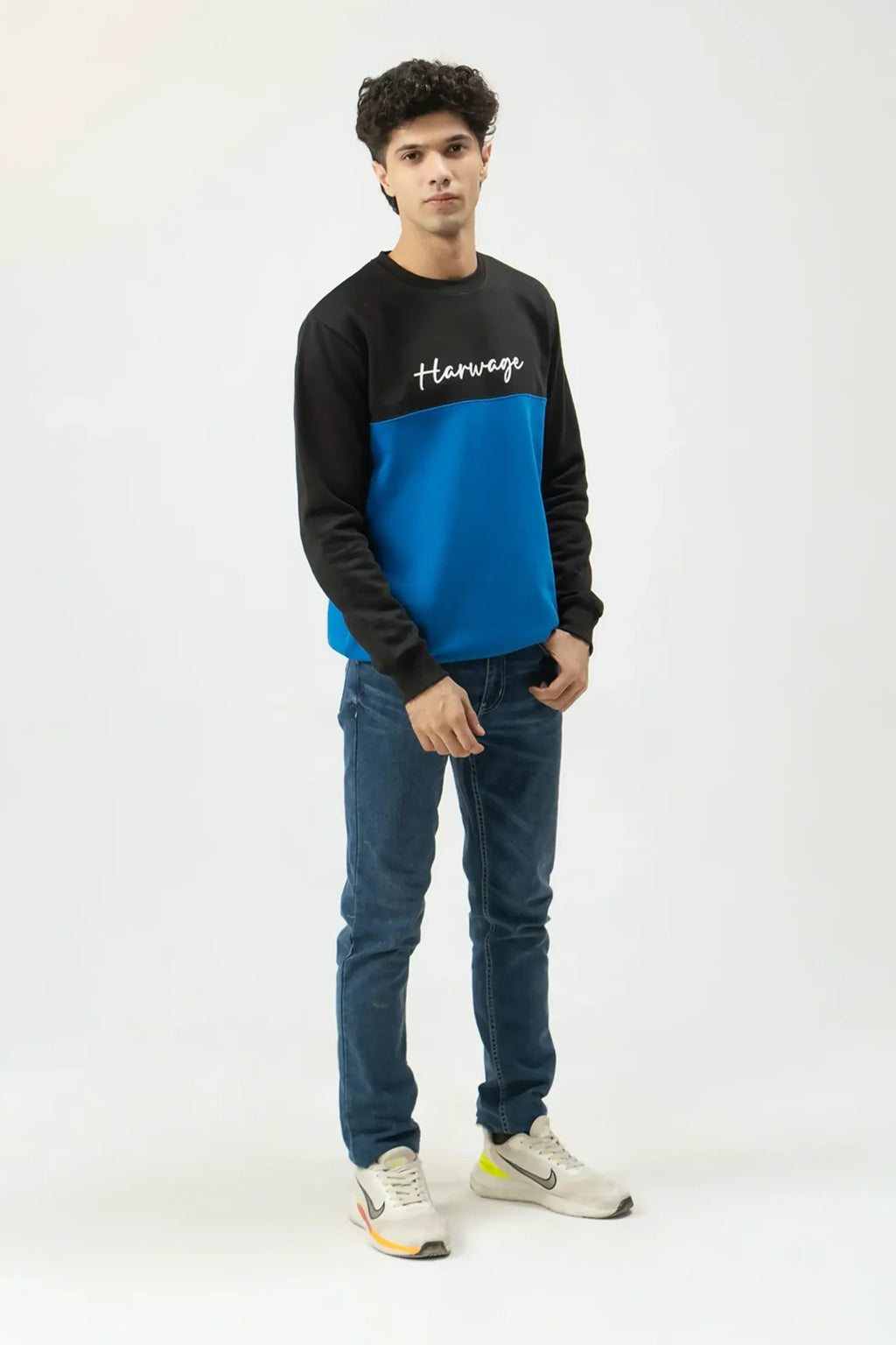 Relaxed front stance showcasing blue and black sweatshirt panels
