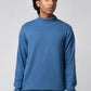 Front view showing turtle neck sweater navy paired with jeans