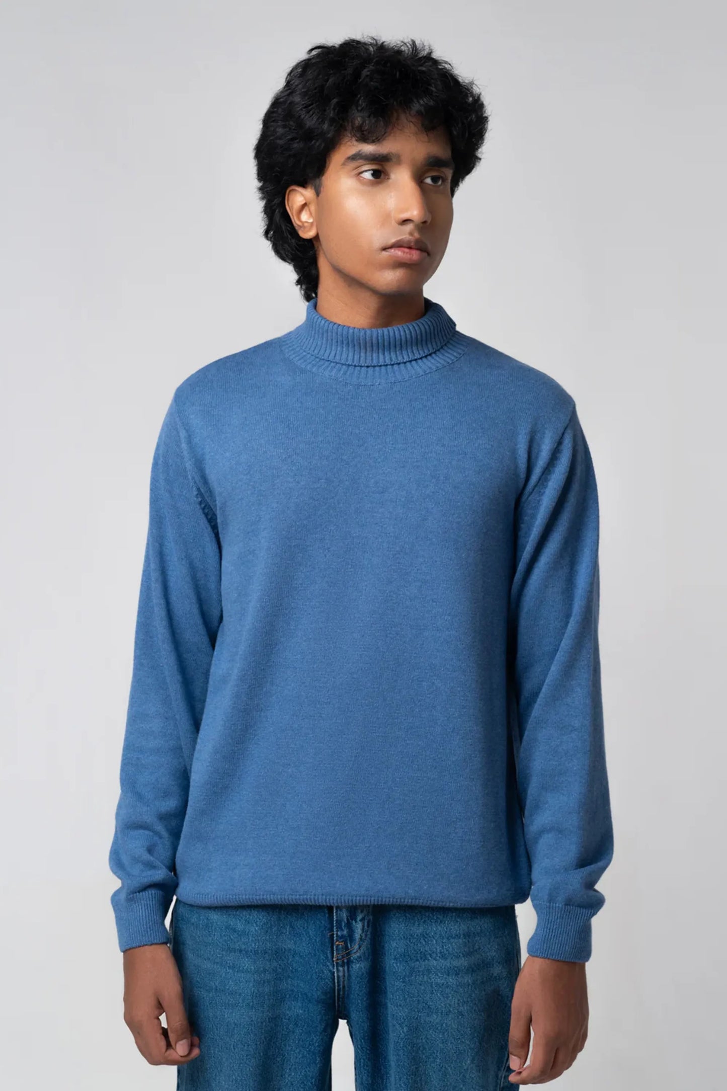 Front view showing turtle neck sweater navy paired with jeans