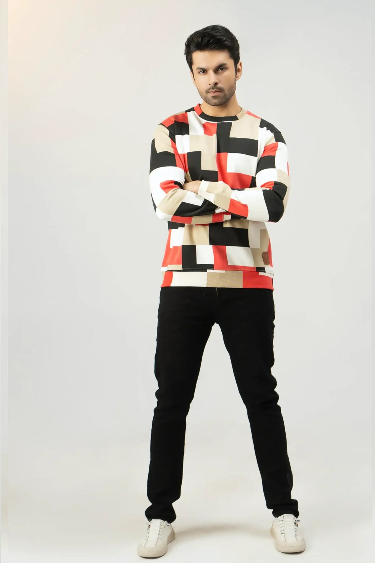 Full-length outfit featuring a geometric-patterned sweatshirt