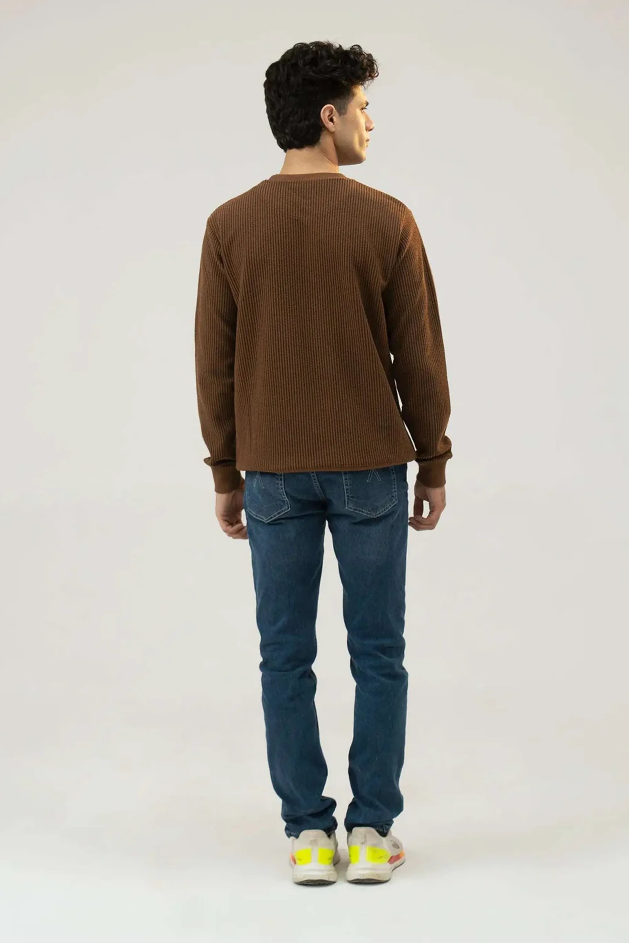 Full back standing view of Brown Regular Fit Sweatshirt paired with denim