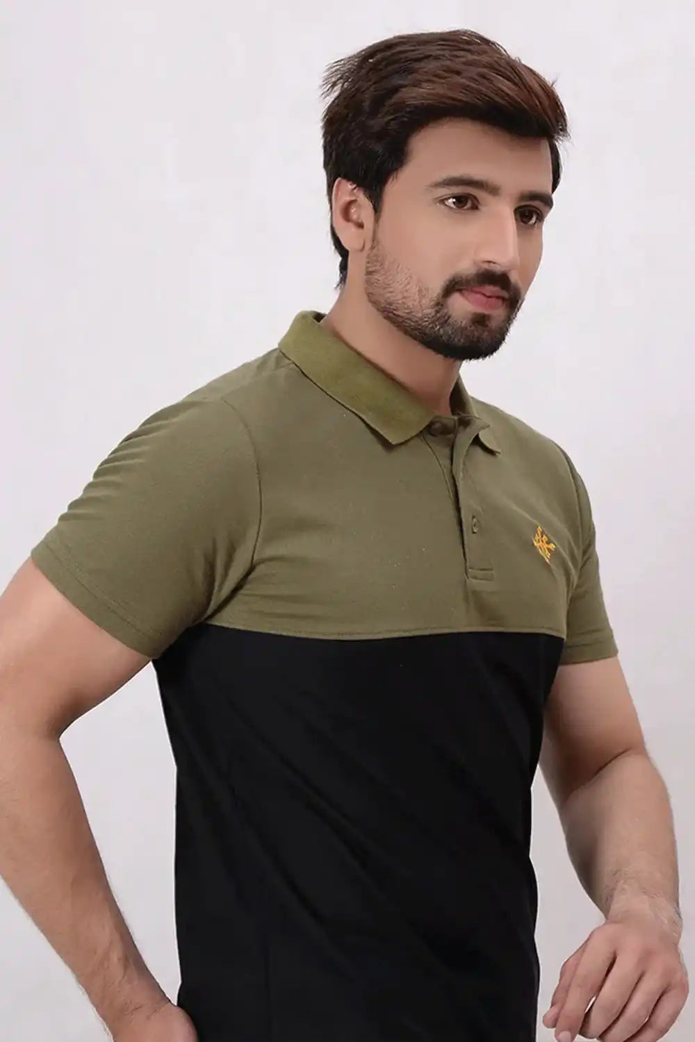 Man wearing a green and black polo shirt on a white background