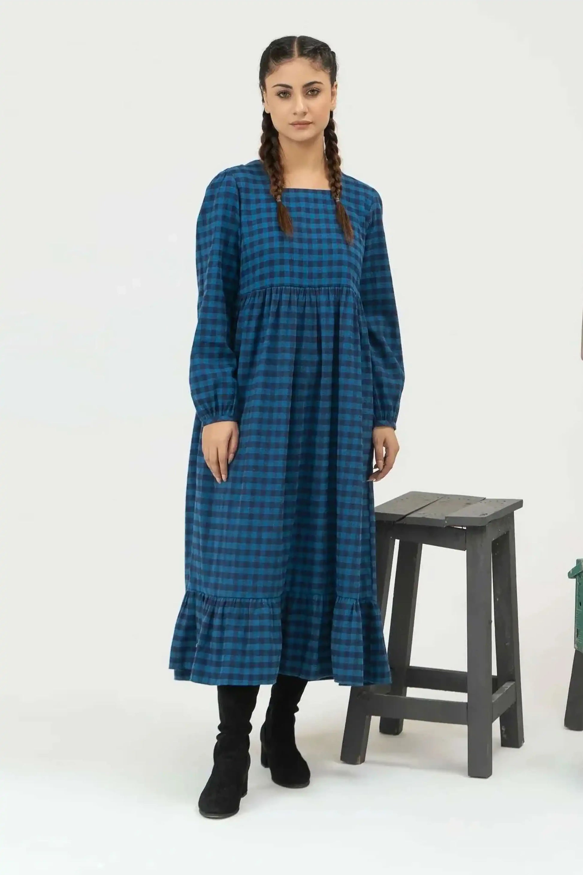 Girl wearing a blue checkered dress 