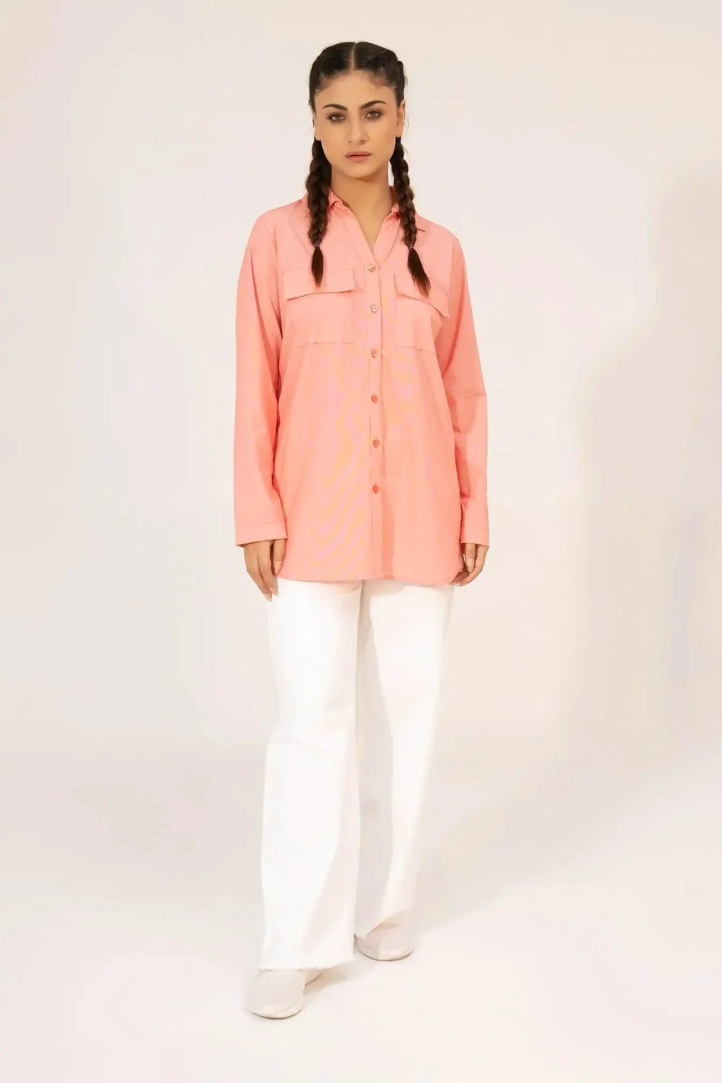 Girl wearing a coral shirt and white pants