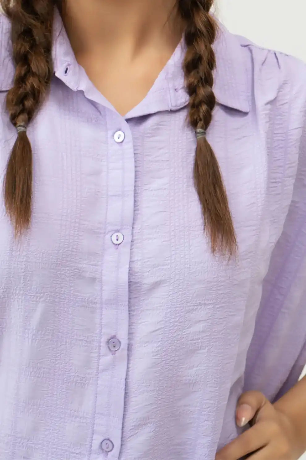 Girl wearing a light purple button-up shirt