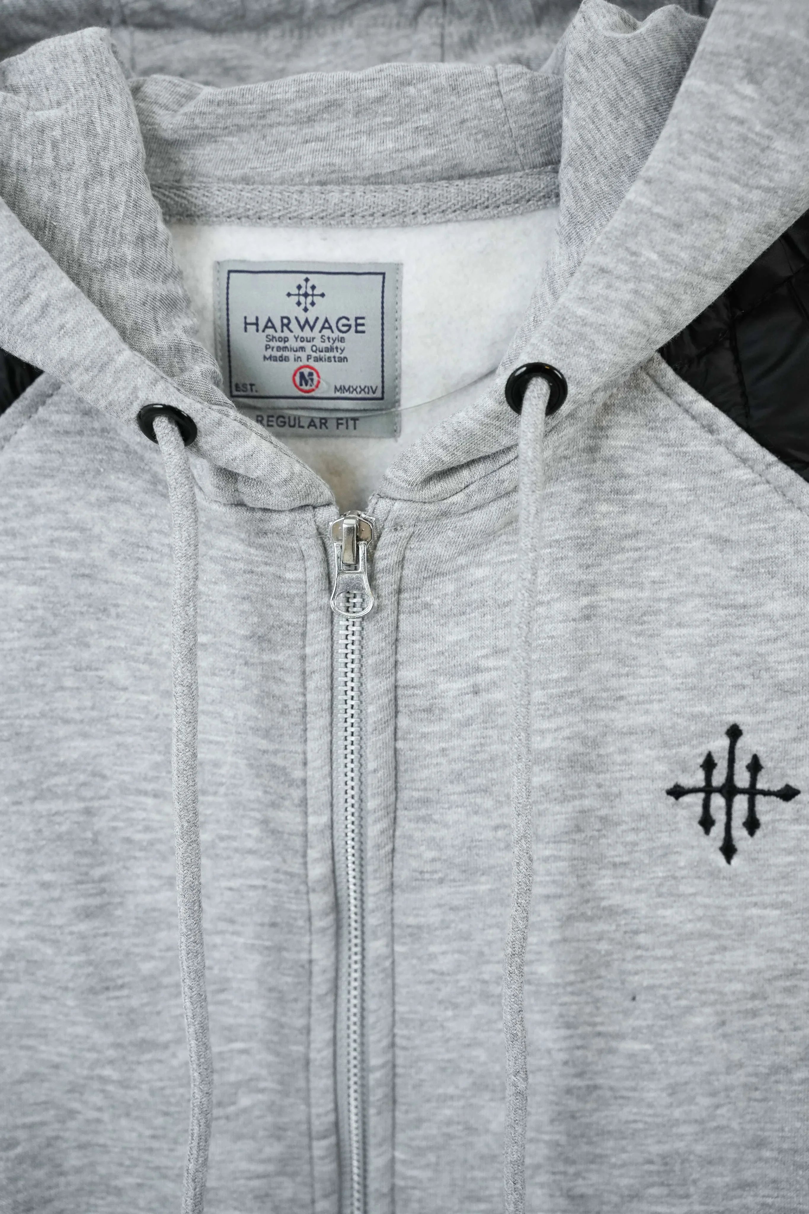 Gray hoodie with Harvage label and black cross emblem on chest
