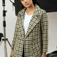 Woman wearing a green and beige checkered coat