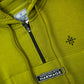 Green hoodie with Harwage branding on a close-up of the chest area