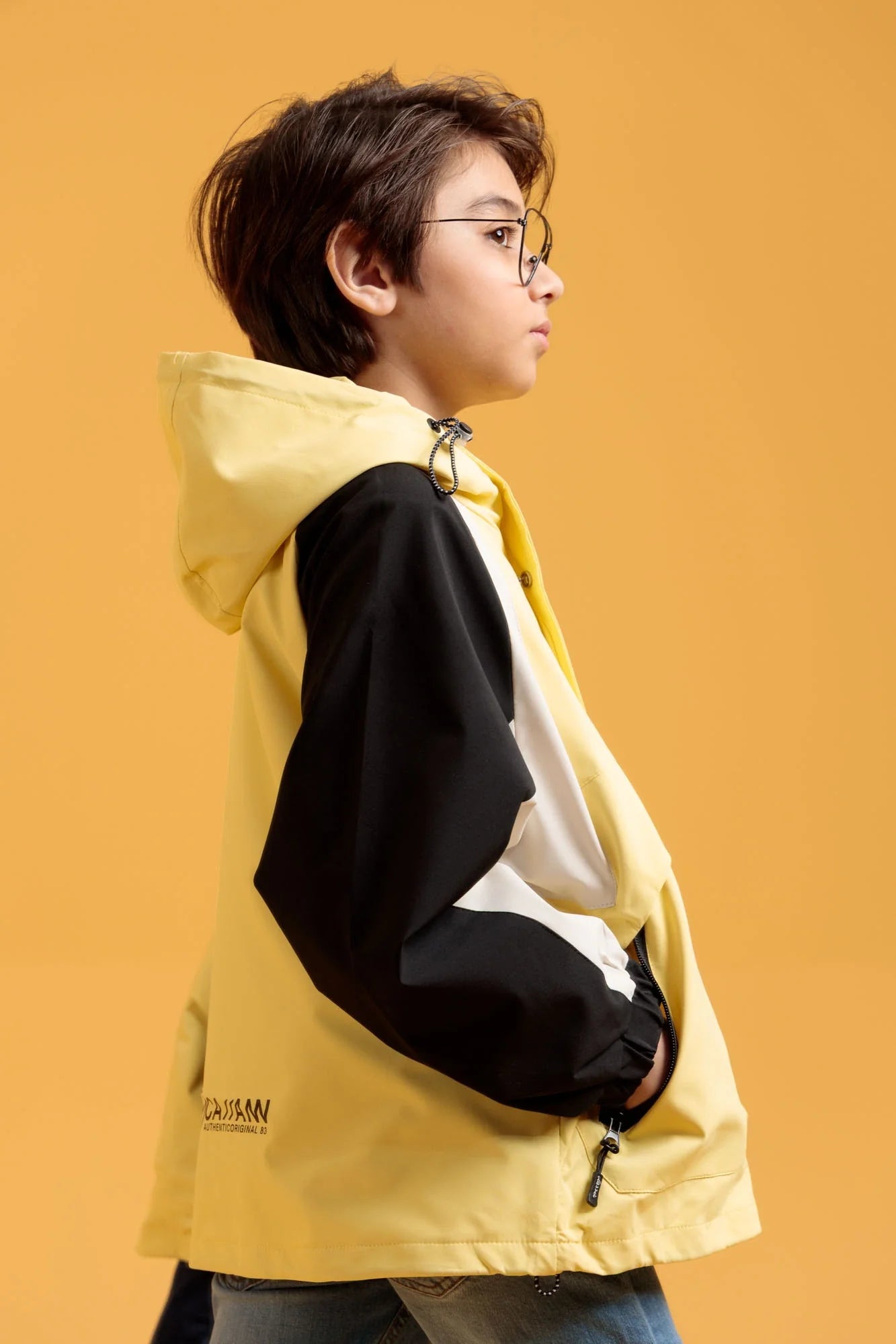 Side profile of a junior boy in a Wind Breaker Jacket