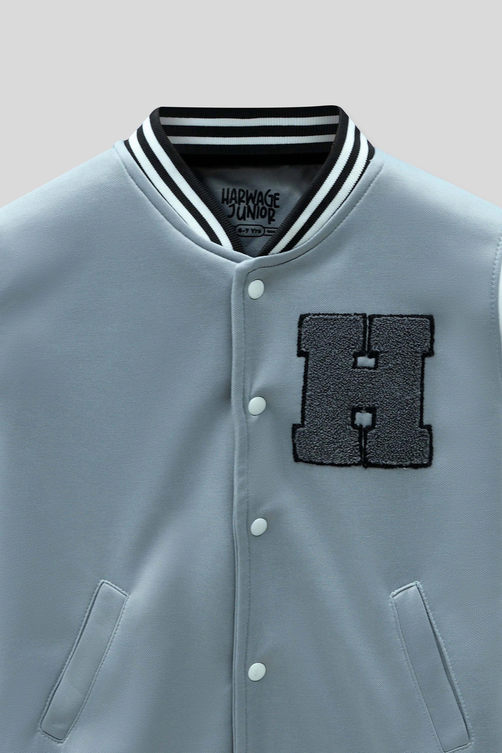 Junior boy styling a baseball jacket with jeans